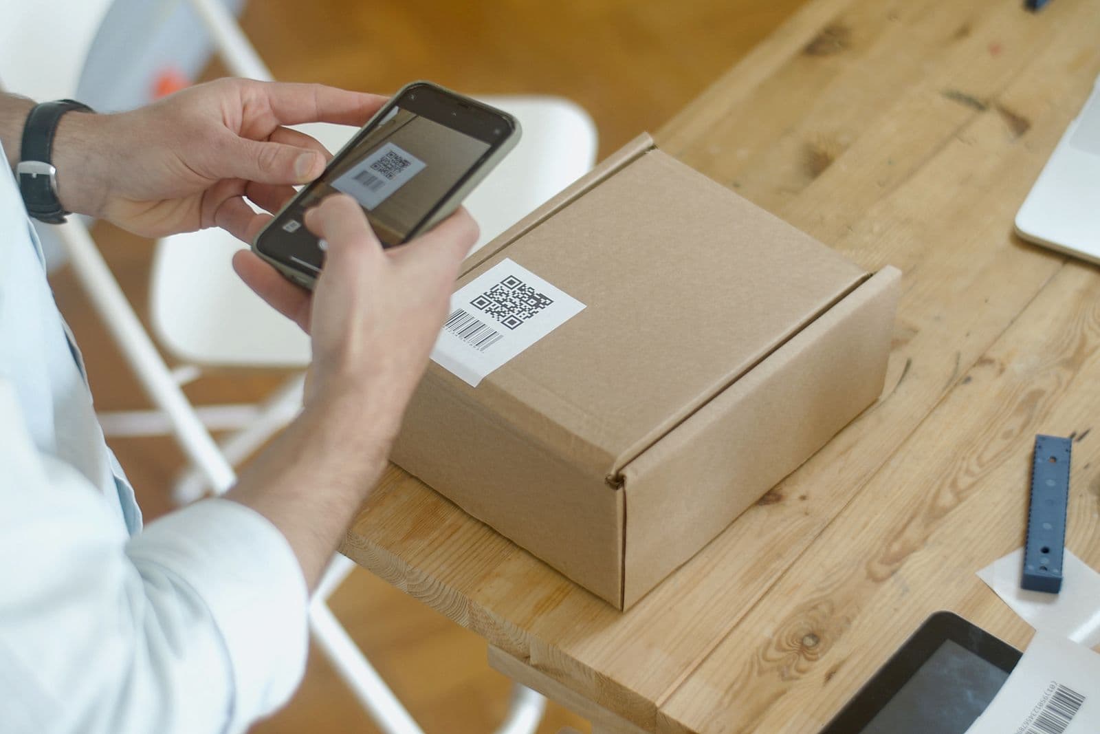 Smartphone scanning a QR code on packaging for buyer traceability certificate verification
